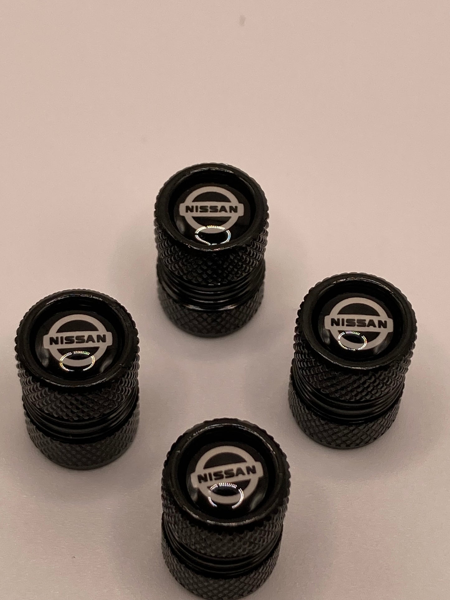 Nissan - black round valve stem cap set - 4pcs