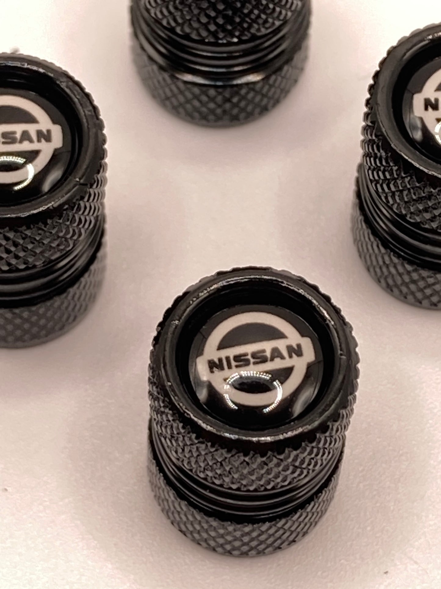Nissan - black round valve stem cap set - 4pcs
