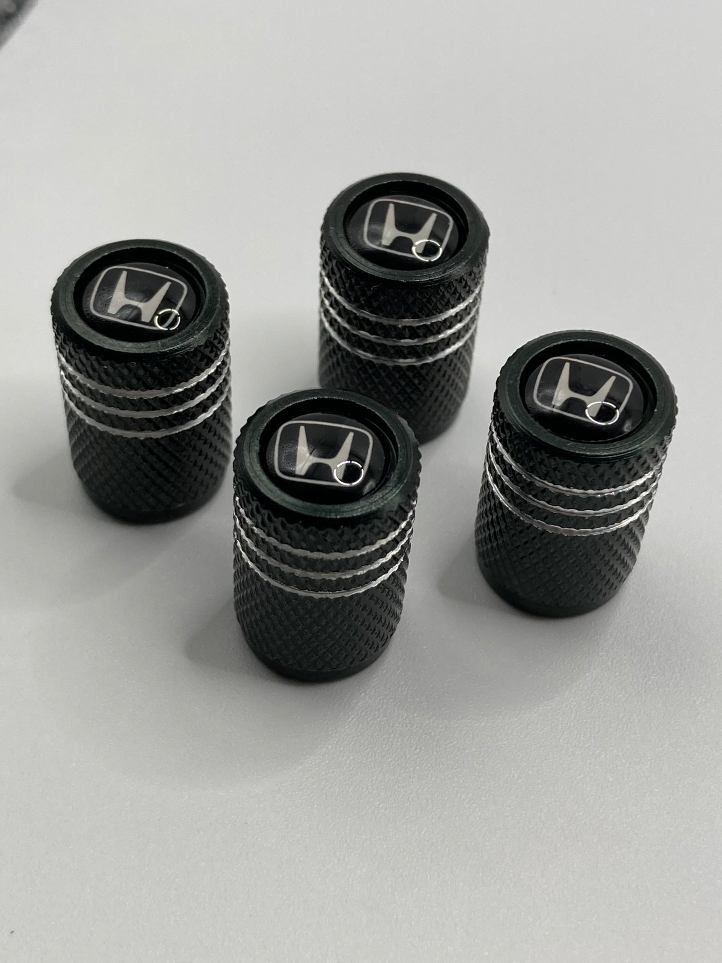 Honda - black/silver valve stem cap set - white logo - 4pcs