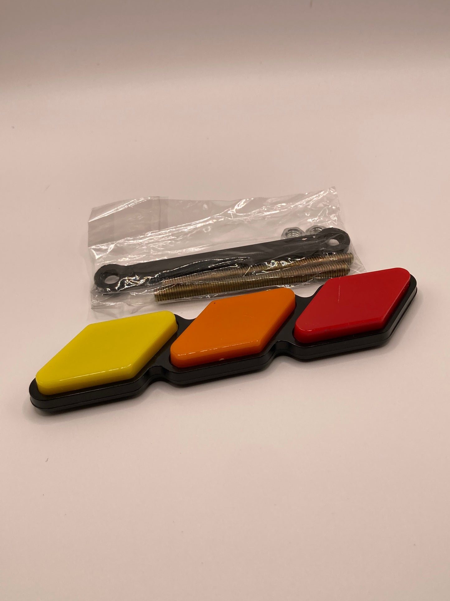 Tri-color grill badge and hardware - red, orange, yellow
