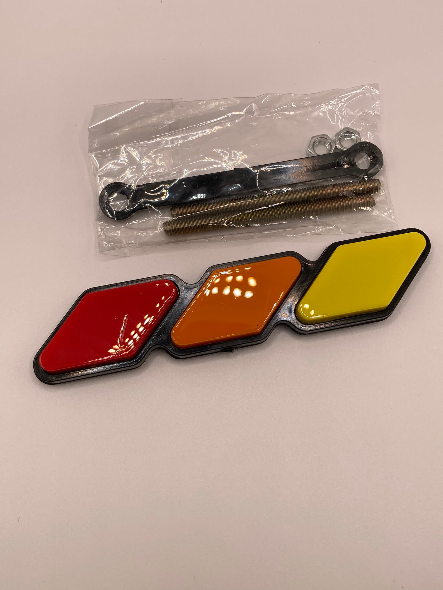 Tri-color grill badge and hardware - red, orange, yellow