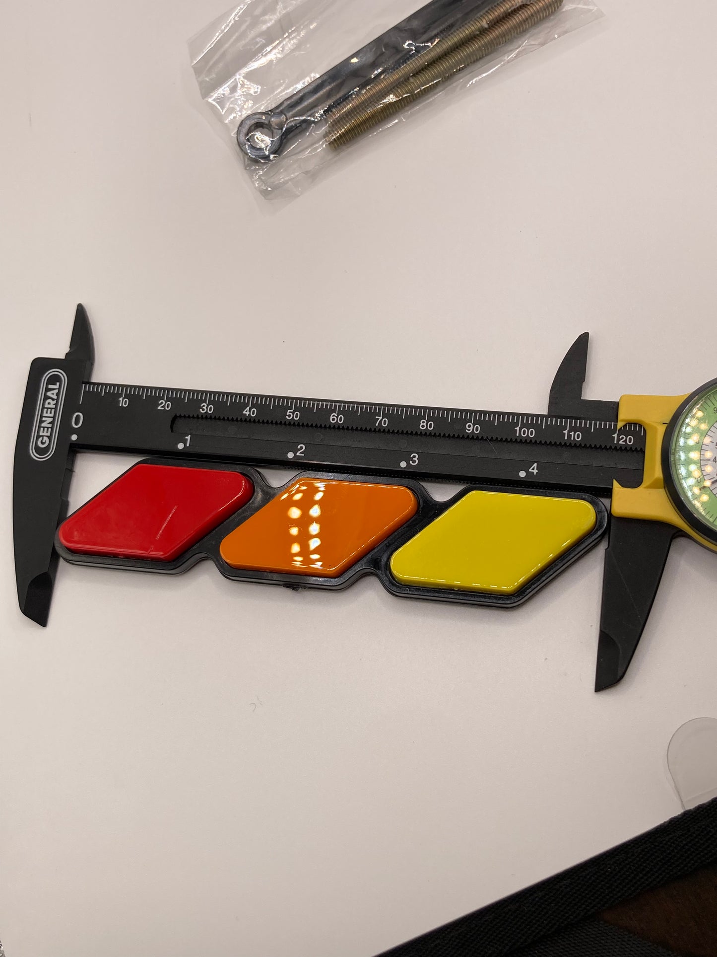 Tri-color grill badge and hardware - red, orange, yellow