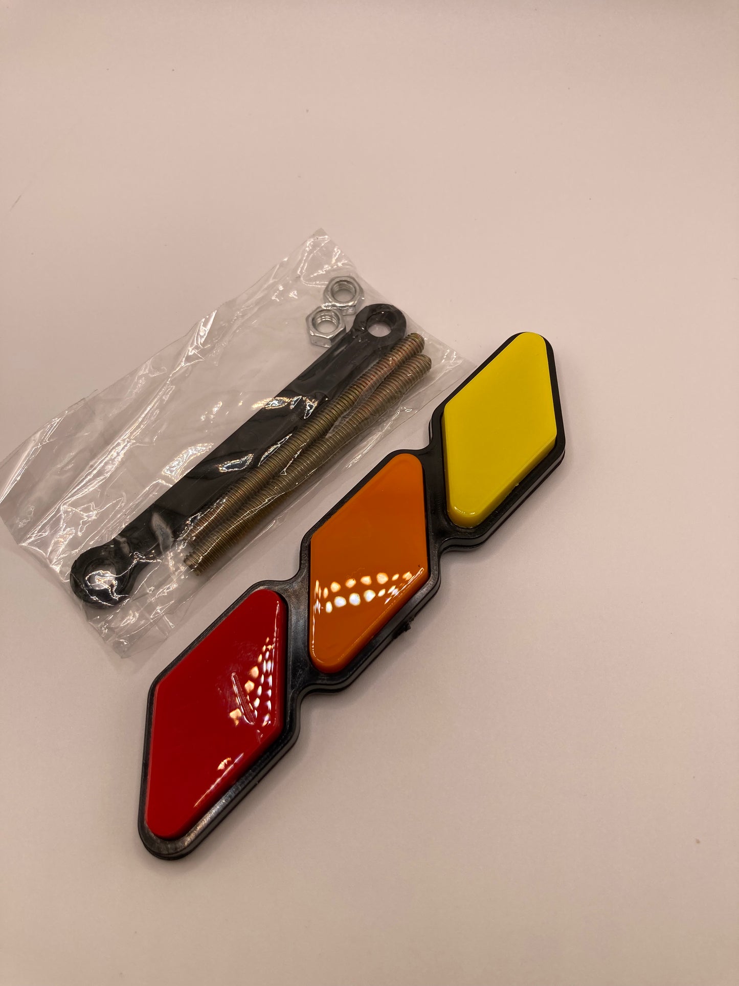 Tri-color grill badge and hardware - red, orange, yellow